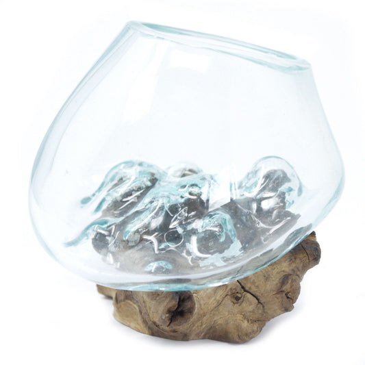Glass bowl with rocks on a wooden base against a white background