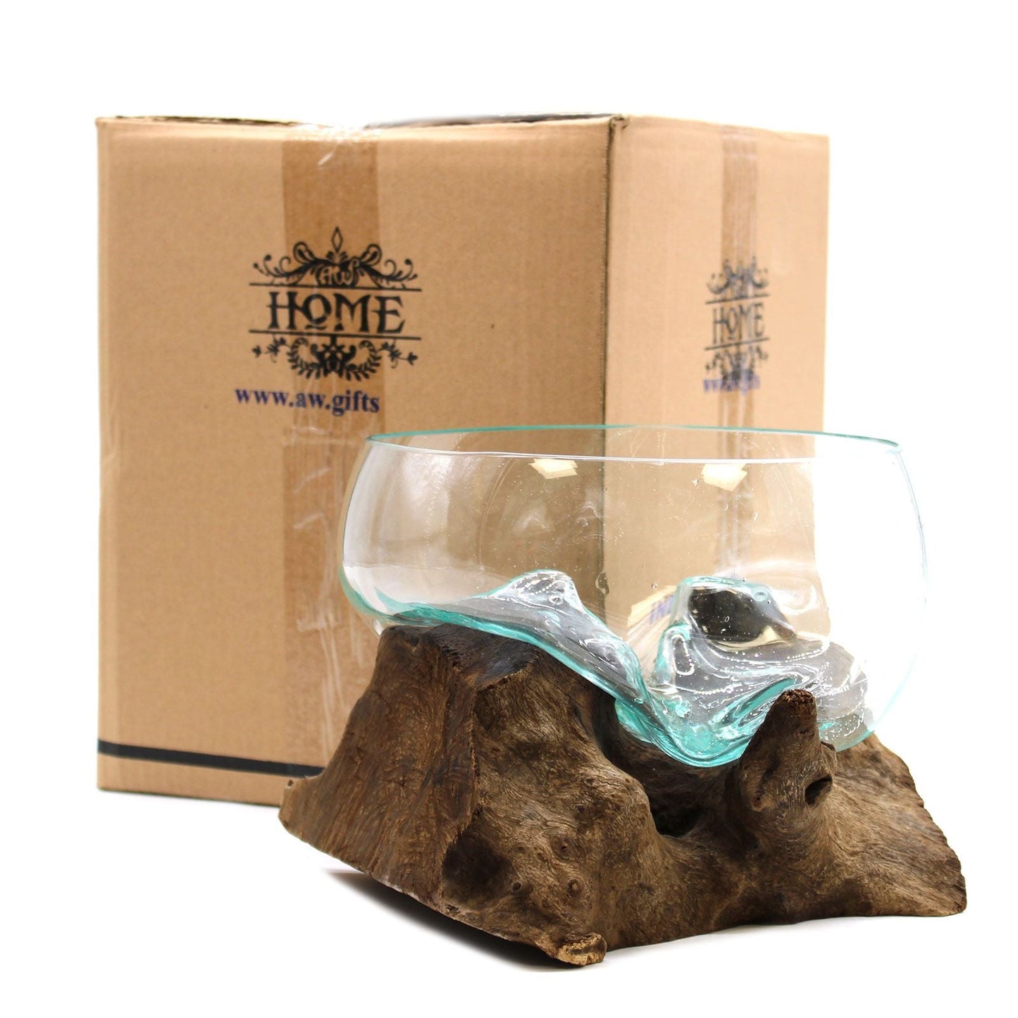 Glass terrarium with succulent on a wooden base next to a patterned candle in a pot.